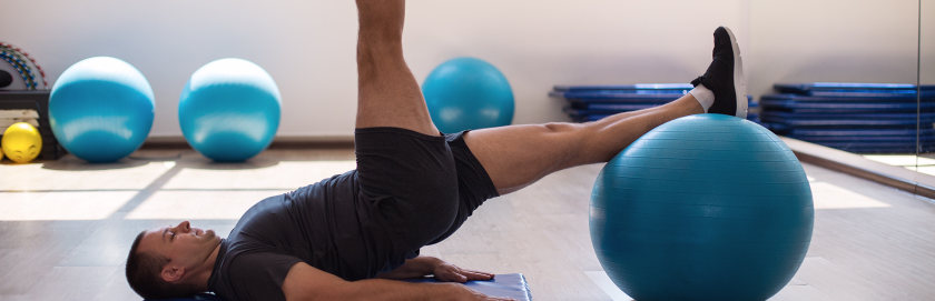 man-single-leg-glute-bridge-swiss-ball