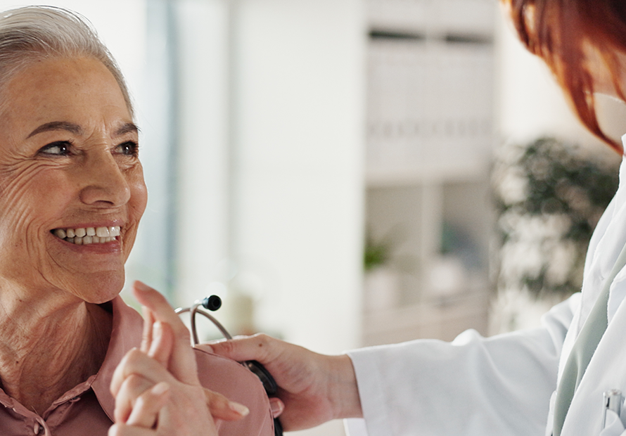 nurse smiles with senior patient-ear flush