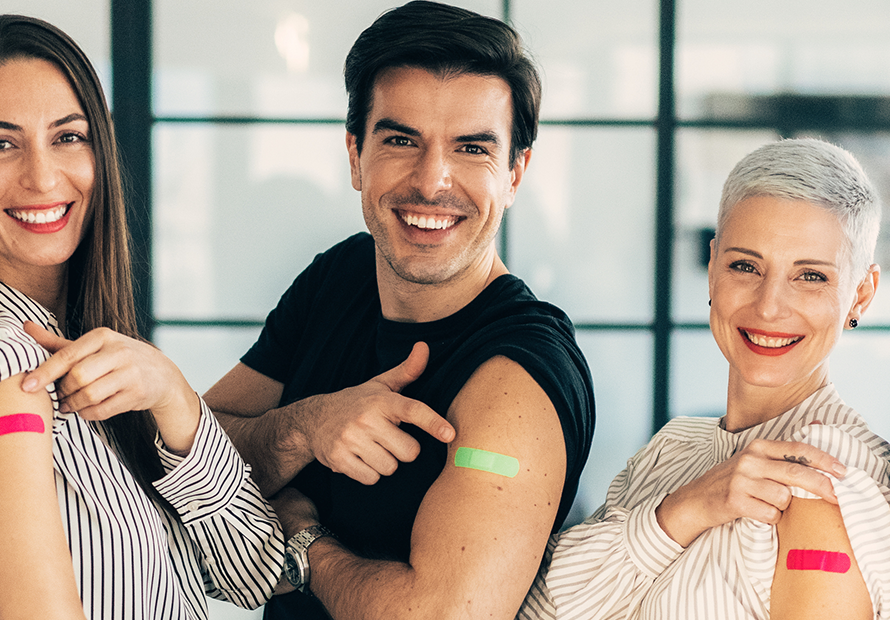 5 adults smile with vaccine bandaids