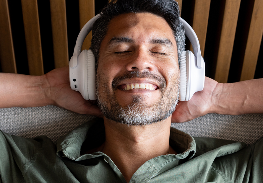 happy man listens to music eyes closed relaxing