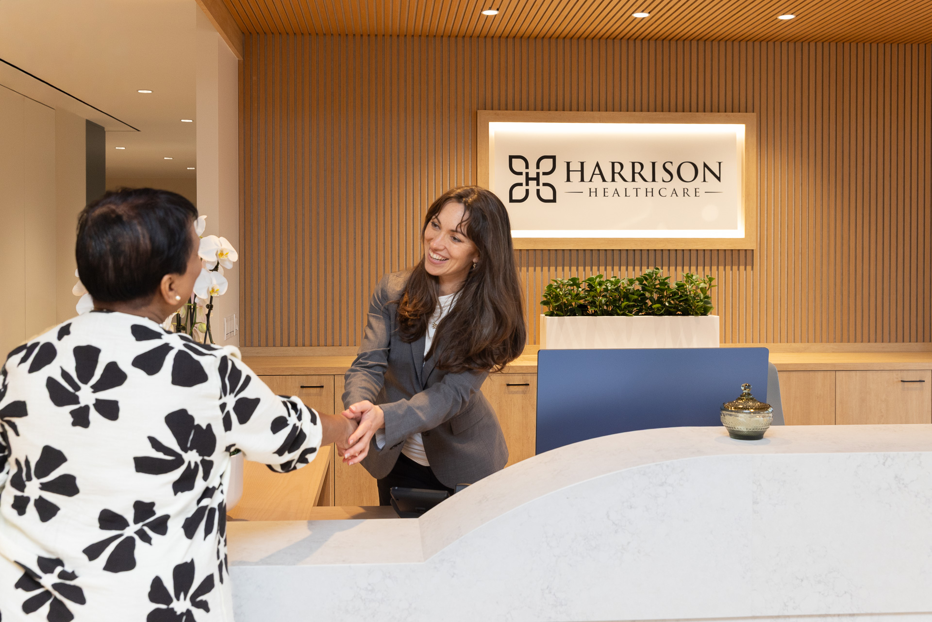 Greeting smiling with client at front desk