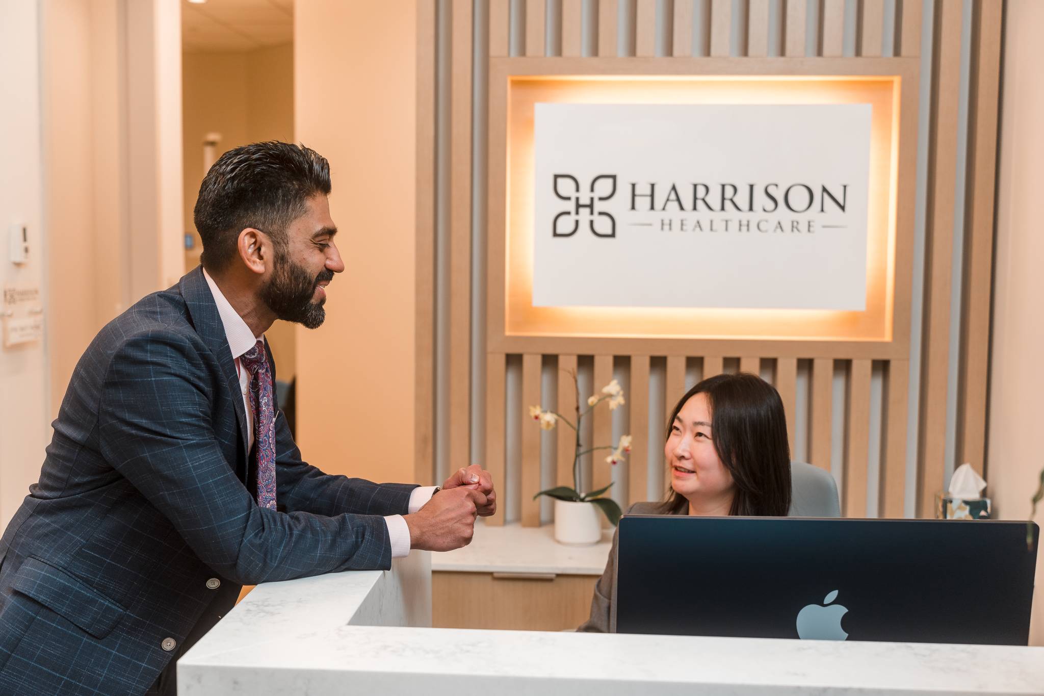 Sitting and smiling with client at front desk