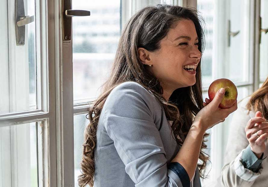 2 women smiling eating healthy food