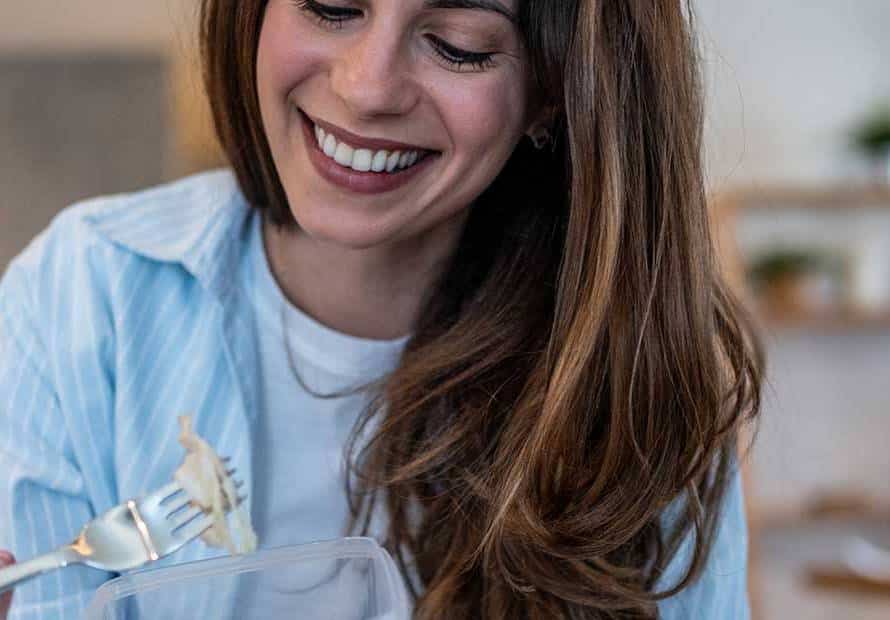 smiling woman eating salad